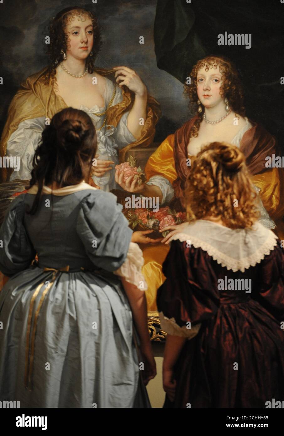 Mädchen im Kostüm aus dem 17. Jahrhundert betrachten ein Gemälde von Anthony van Dyck von Dorothy Savage und ihrer Schwester Elizabeth, Lady Thimbleby in der Tate Britain, London. Stockfoto