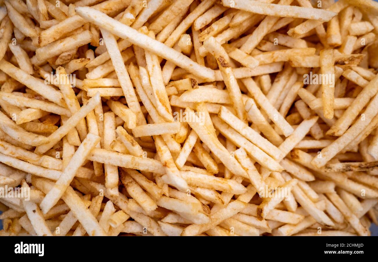 Kartoffelchip-Sticks. Full Frame close Detail abstrakte Hintergrundstruktur einer Schüssel mit Pommes frites. Stockfoto