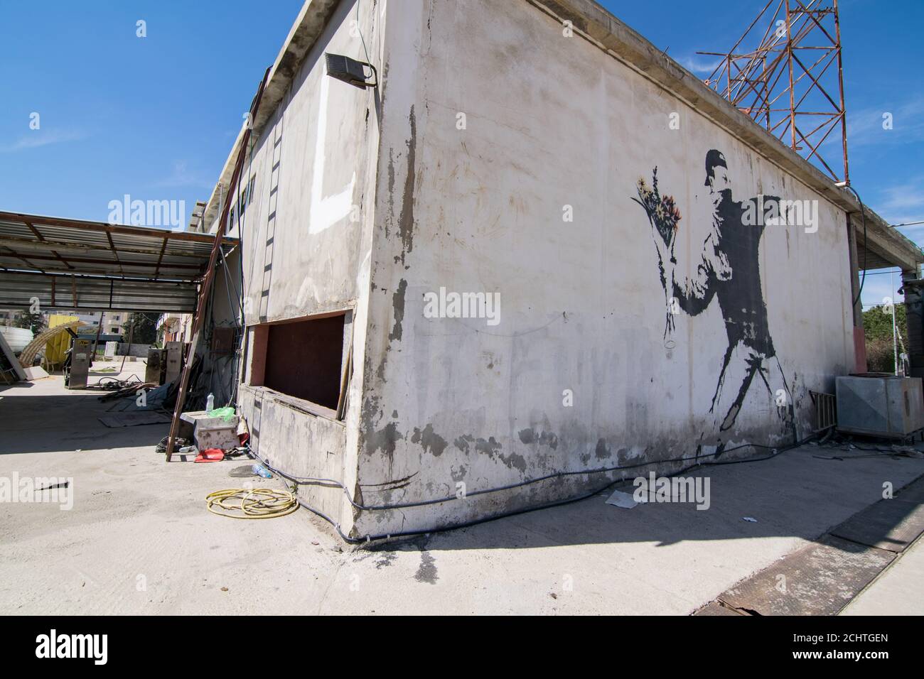 Banksy's berühmtes Wandbild 'Wut, der Blumenwerfer (Liebe ist in der Luft)', das auf einer Autowäsche in einem Vorort von Betlehem (Palästina) gemalt ist Stockfoto