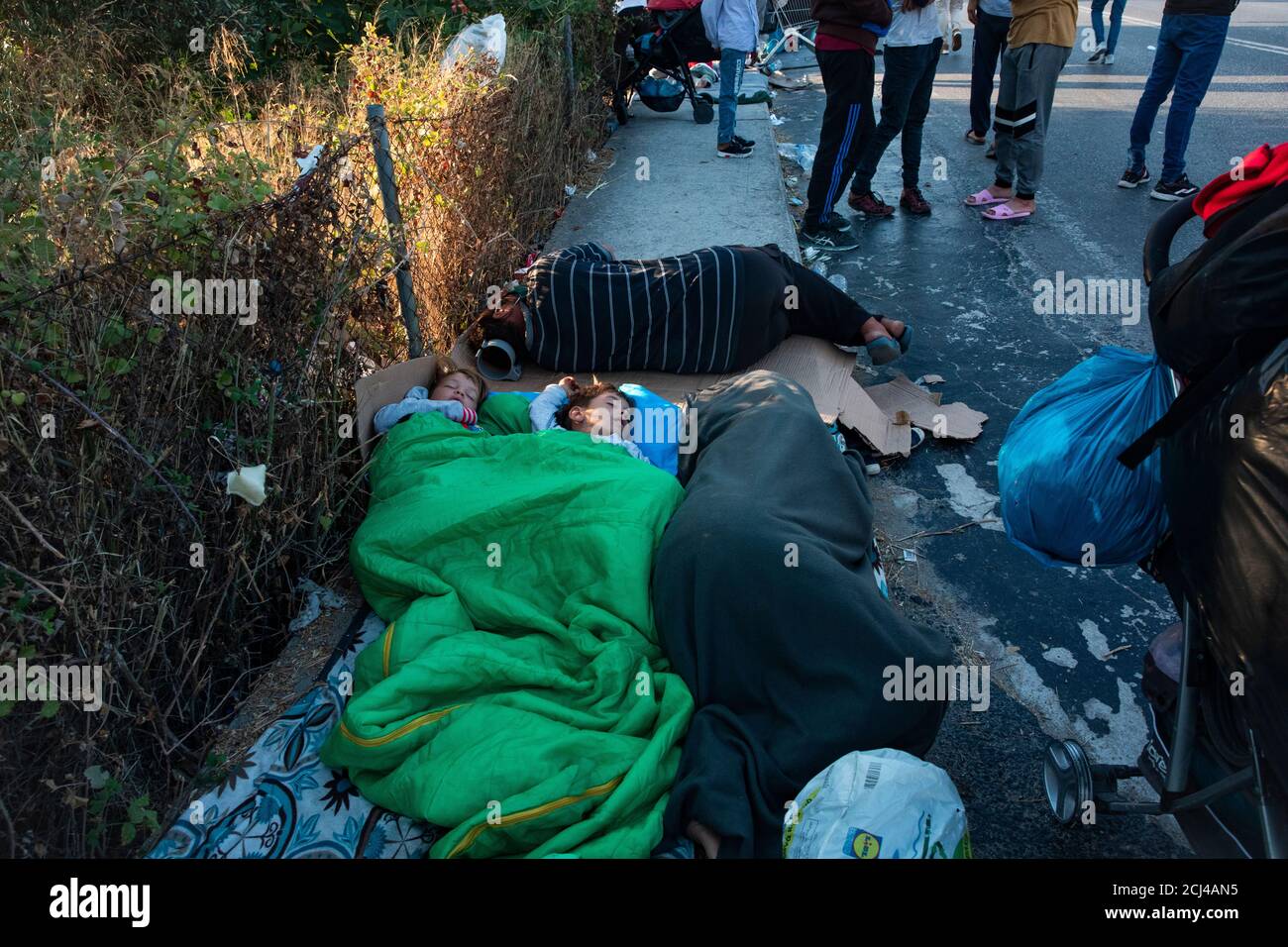 Kinder aus afghanistan schlafen auf der Straße umringt von anderen verzweifelten Migranten in Mytilene, nachdem sie aus einem Inferno geflohen sind, das das Flüchtlingslager Moria auf der Insel Lesbos zerstörte.Mehr als 13,000 Asylsuchende fliehen vor dem Feuer auf Griechenlands größtem Wanderlager Moira in lesbos. Sie wurden auf der Straße vor der Stadt mitilini gestrandet und von der Polizei daran gehindert, den Hafen zu betreten. Stockfoto