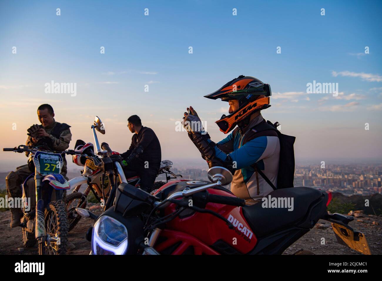 Urumqi. September 2020. Das am 10. September 2020 aufgenommene Foto zeigt den Motorradfahrer Gao Dongxu (R), der mit seinem Telefon in den Bergen nahe Urumqi, der nordwestlichen chinesischen Autonomen Region Xinjiang Uygur, fotografiert. Gao Dongxu, 39 Jahre alt, und seine Freunde sind Langlaufbegeisterte, die gerne neue Reitwege in den Bergen erkunden. Quelle: Hu Huhu/Xinhua/Alamy Live News Stockfoto