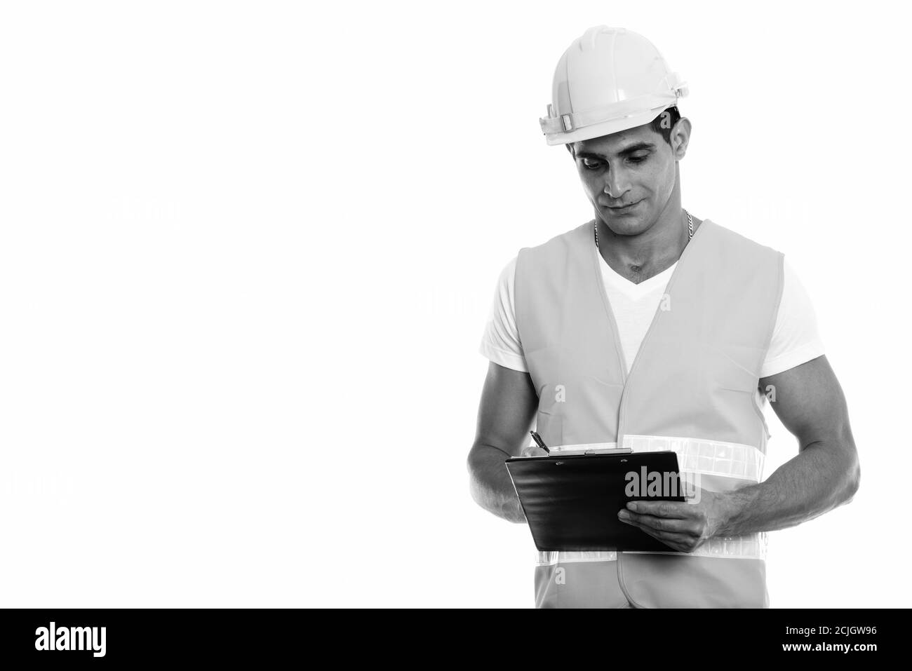 Studio Aufnahme von jungen muskulösen persischen Mann Bauarbeiter schriftlich In der Zwischenablage Stockfoto