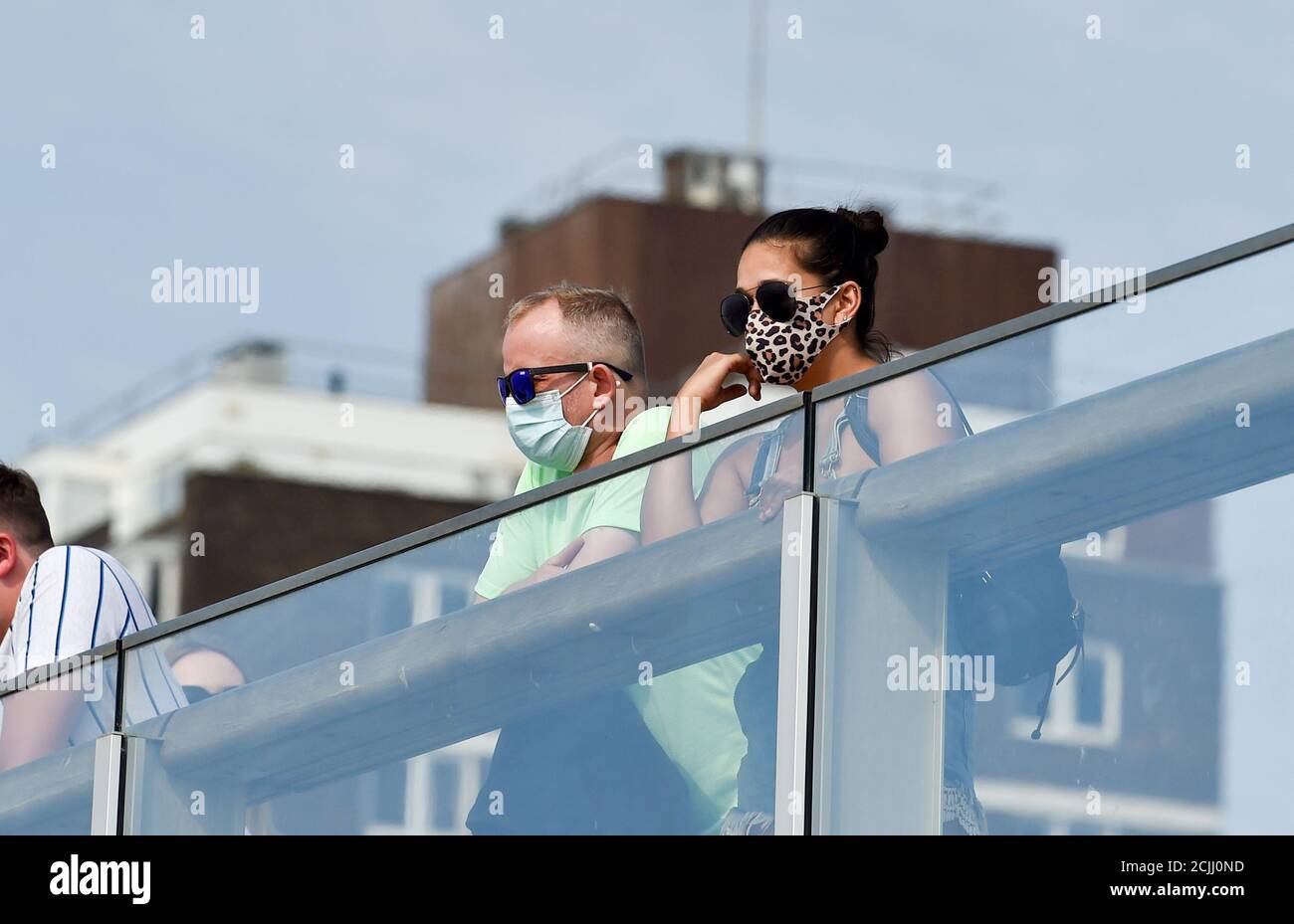 Brighton UK 15. September 2020 - Besucher mit Gesichtsbezügen an der Küste von Brighton können einen weiteren heißen Tag am Meer nutzen, da die Temperaturen in einigen Teilen des Südostens wieder auf 30 Grad steigen werden : Credit Simon Dack / Alamy Live News Stockfoto