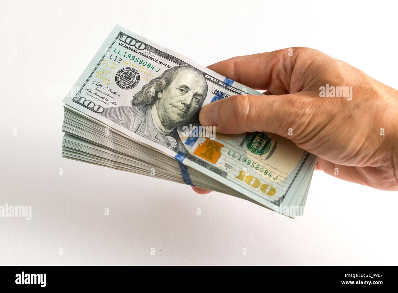 Hand, die 100-Dollar-Scheine Stockfoto
