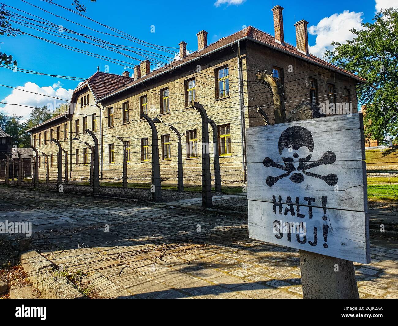 Auschwitz Birkenau, Polen. August 2020. Auschwitz, Polen 25. August 2020: Konzentrationslager Auschwitz-Birkenau - 08/25/2020 Schild mit Totenkopf, Halt, Stoj, Stacheldraht, Gebäude Quelle: dpa/Alamy Live News Stockfoto