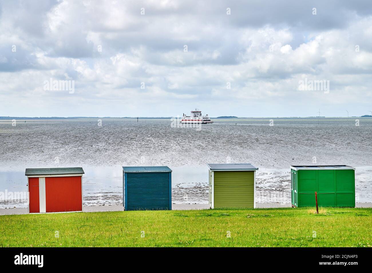 Blick über bunte Strandstände zum Watt mit einem Fähre Stockfoto
