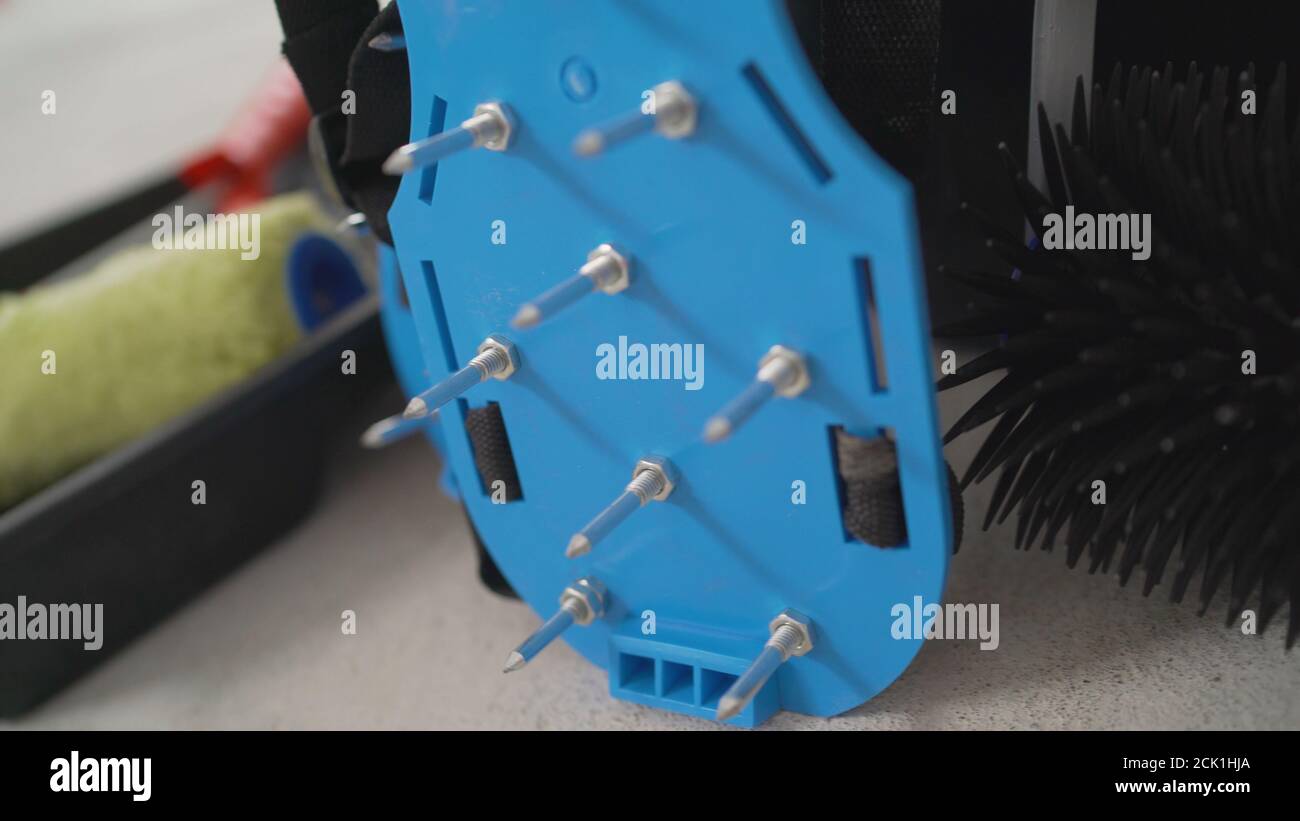 Wanderschuhe mit Nadelrolle und nassem Estrich. Nadelrolle für selbstnivellierenden Boden. Betonboden. Am Horizont. Nahaufnahme. Nadelrolle zu Stockfoto