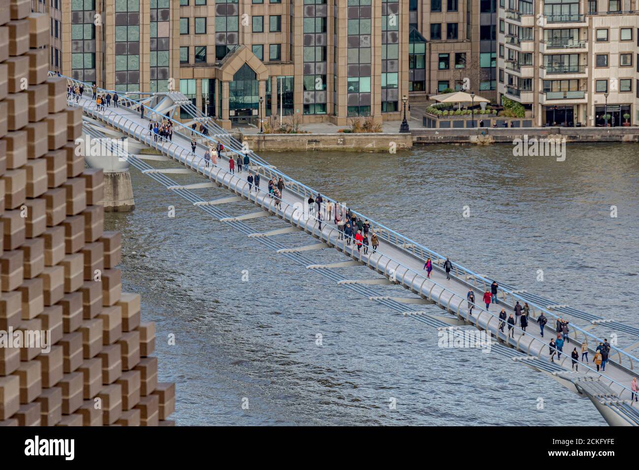 Menschen, die die Millennium Footbridge überqueren, eine Stahlhängebrücke über die Themse in London, die Bankside mit der City of London verbindet Stockfoto