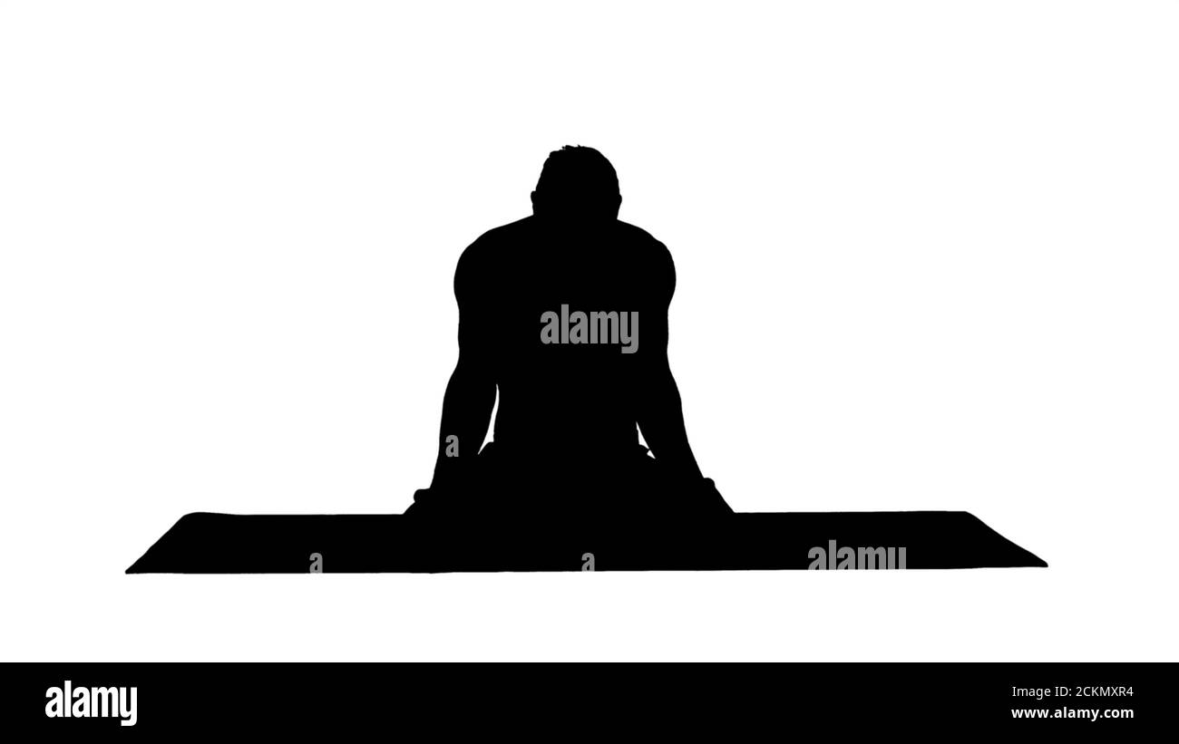 Silhouette junger Mann praktiziert Yoga in Lotusposition. Stockfoto