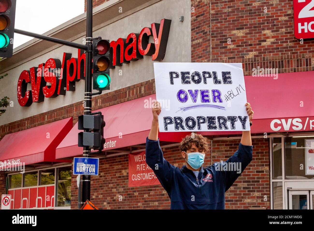 Washington, DC, USA, 16. September 2020. Im Bild: Ein Protestler hält ein Schild über seinem Kopf, das sagt, dass Menschen über Eigentum geschätzt werden sollten, eine direkte Kritik an diesem CVS-Laden. Der Protest fand statt, weil am Tag zuvor der CVS-Store-Manager die Polizei wegen zweier 'suspicious' schwarzer Männer anrief. Sechs Metropolitan (DC) Polizeibeamte nahmen die beiden Männer fest und ließen sie schließlich frei, nachdem eine Durchsuchungsstelle keine gestohlenen Gegenstände gefunden hatte. Angesichts der erheblichen Gefahr von Gewalt, wenn die Polizei auf schwarze Männer gerufen werden, kam eine Reihe von Menschen, um gegen die Entscheidung des Managers zu protestieren. Kredit: Allison C Bailey/Alamy Stockfoto