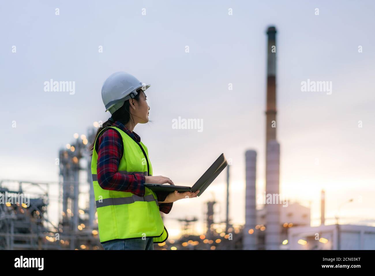Asiatische Frau petrochemische Ingenieur arbeiten bei Nacht mit Notebook im Inneren Öl-und Gasraffinerie-Anlage Industrie Fabrik in der Nacht für inspector Sicherheit qua Stockfoto