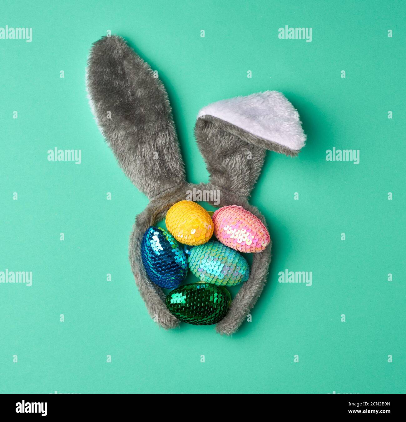 Bunte dekorative Ostereier verziert mit Pailletten auf einem grünen Hintergrund Stockfoto