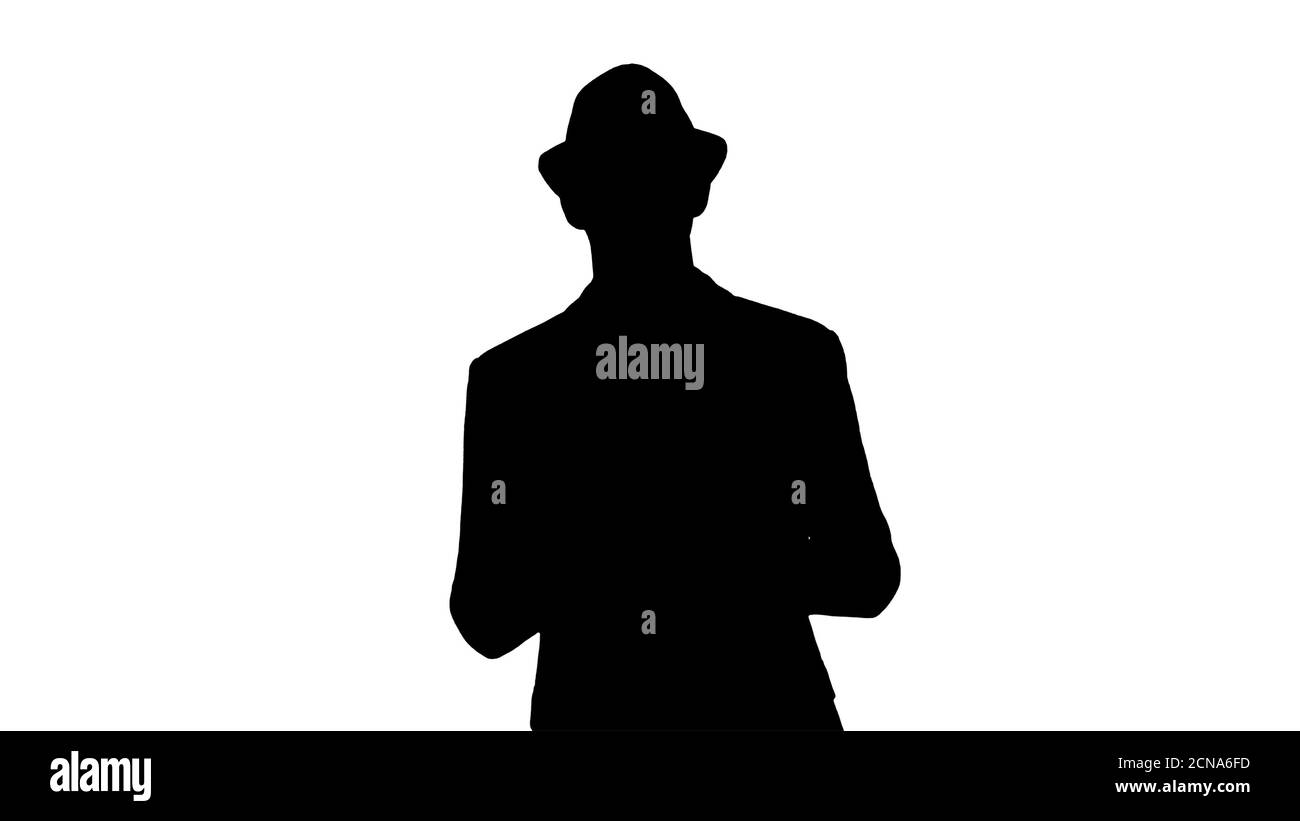 Silhouette Gelegenheitlicher Mann in einem Hut zu Fuß und zeigt digitale Tablette zur Kamera. Stockfoto