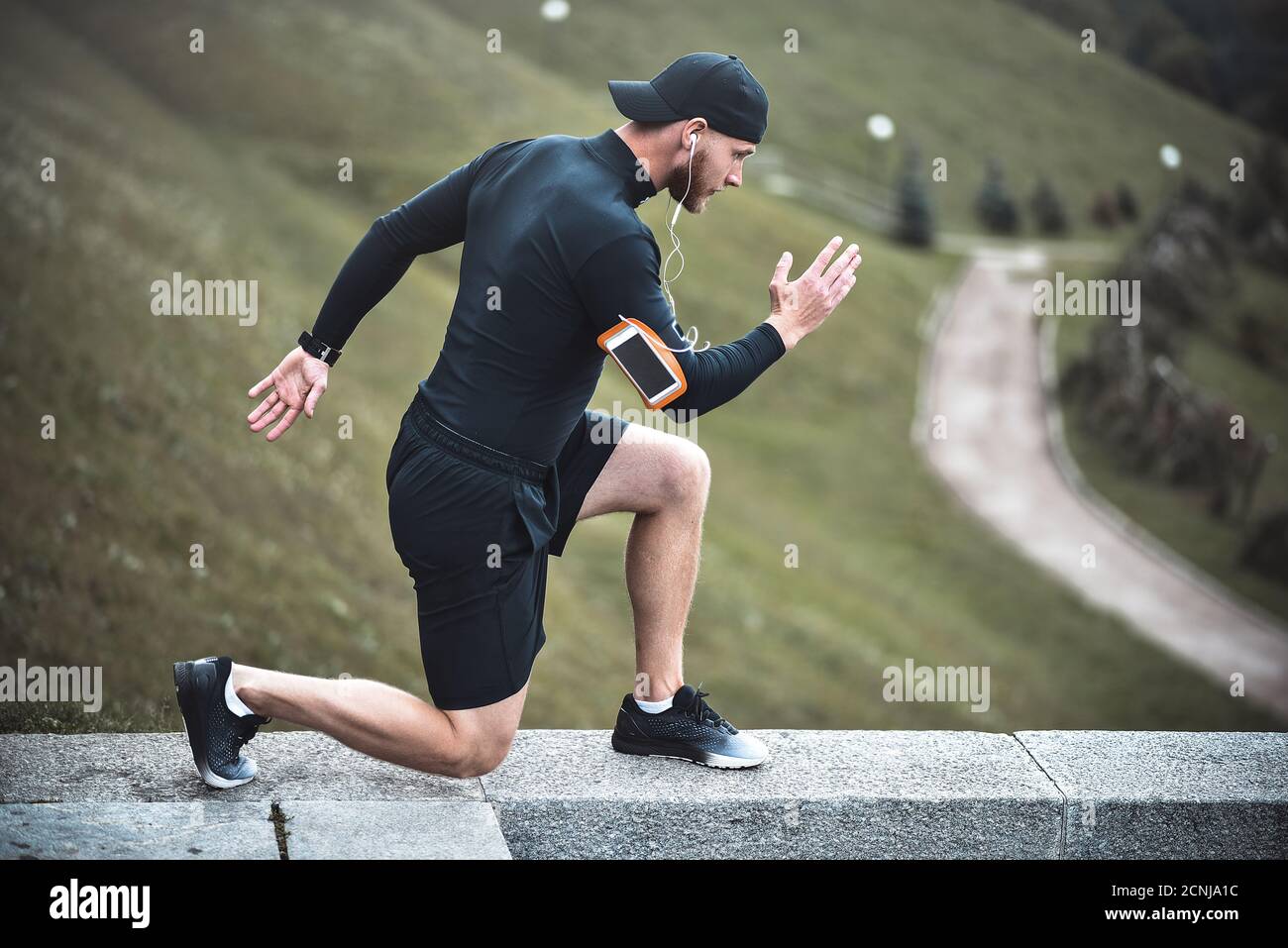 Muskulöse Sportler Stretching vor dem Sport Ausbildung an der Straße im City Park Stockfoto