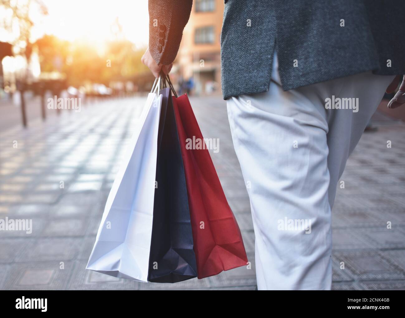 Konzept der Mann einkaufen und halten Taschen, Nahaufnahmen. Nahaufnahme von Papier Einkaufstaschen in männlicher Hand. Stockfoto