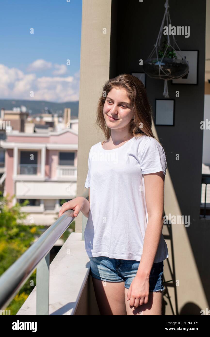 Teenager Mädchen auf dem Balkon posiert und lächelt. Home-Konzept Stockfoto