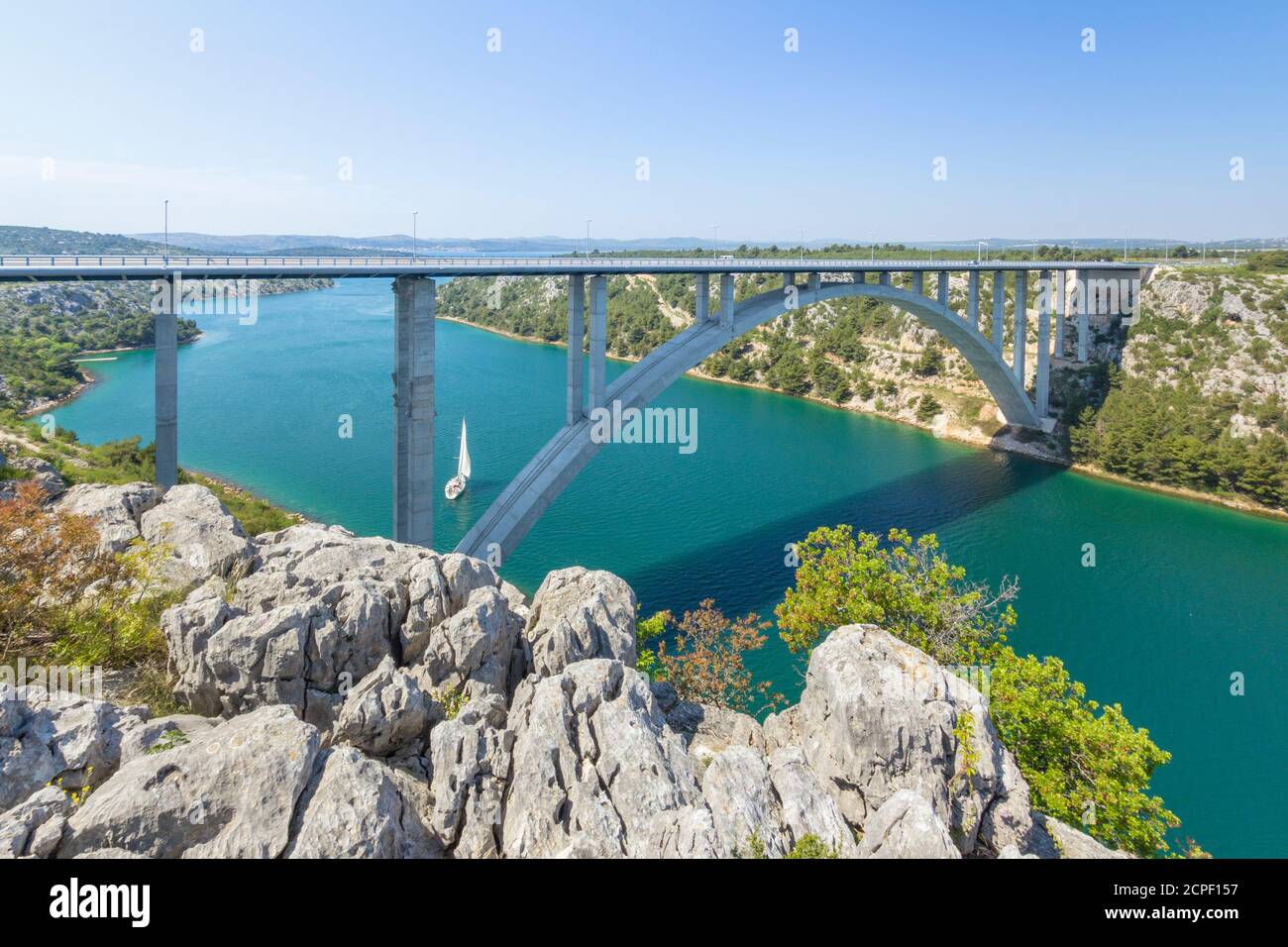 Eine Autobahn Brücke über den Fluss Krka in der Nähe der Stadt Trogir, Šibenik-Knin, Kroatien. Segelboote Segeln auf dem Fluss. Stockfoto