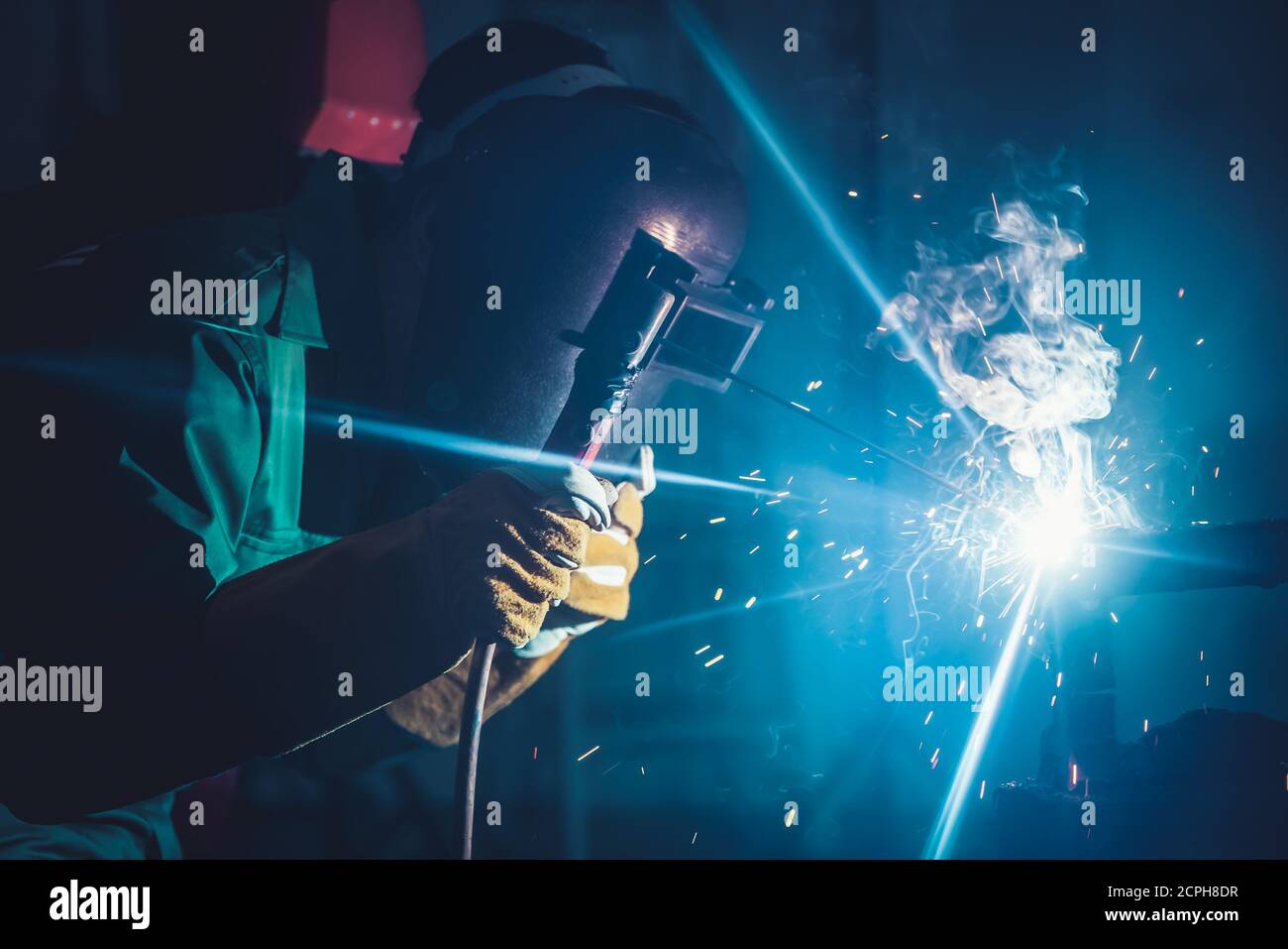Metallschweißstahl arbeitet mit Lichtbogenschweißmaschine, um Stahl im Werk zu schweißen. Metallverarbeitung Herstellung und Bau Wartung Service durch Stockfoto