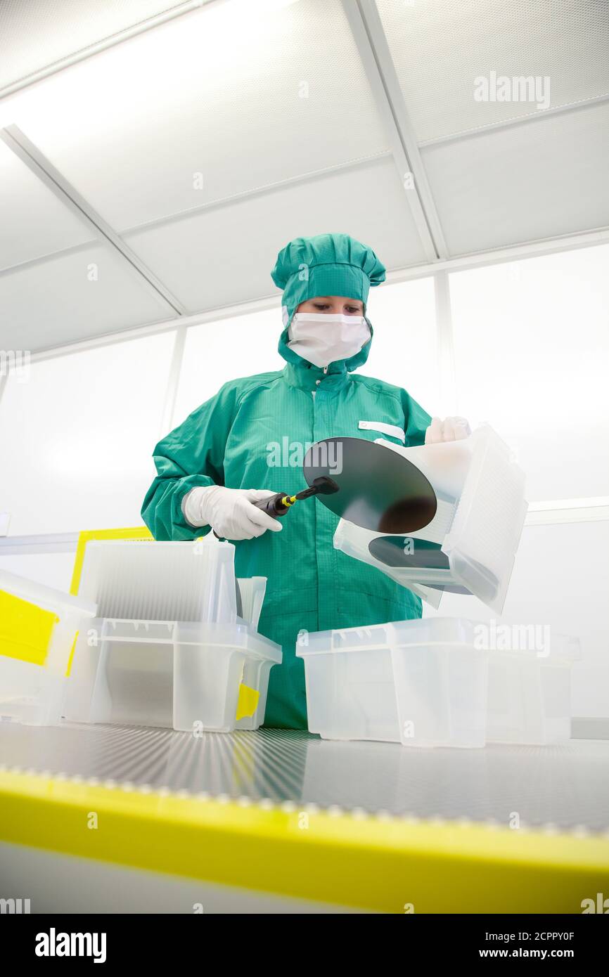 Duisburg, Nordrhein-Westfalen, Deutschland - Hochtechnologie im Ruhrgebiet. Ein Mikrotechnologe im Wafer-Handling im Reinraum am Stockfoto