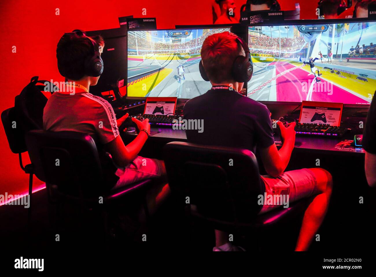 Jungen spielen Computerspiele vor Bildschirmen, Fachmesse für Computer- und Videospiele Gamescom, Köln, Nordrhein-Westfalen, Deutschland Stockfoto