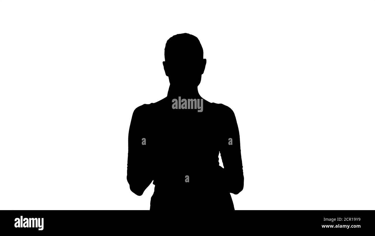 Silhouette Junge Frau macht Notizen beim Gehen. Stockfoto