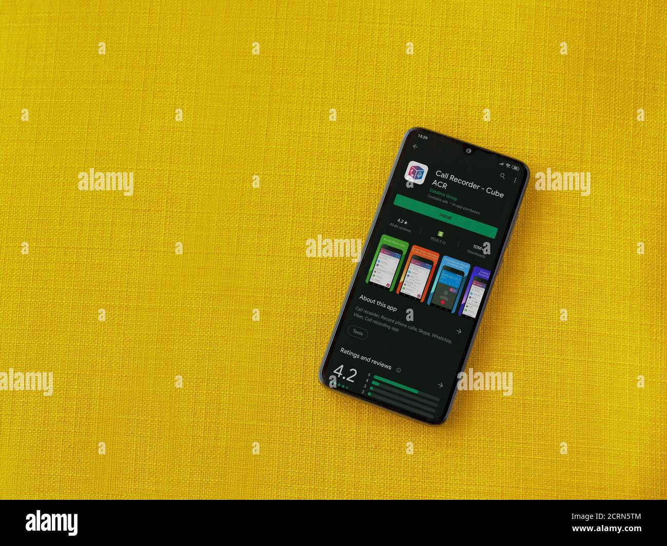 LOD, Israel - 8. Juli 2020: Cube ACR App Play Store Seite auf dem Display eines schwarzen Smartphone auf einem gelben Stoff Hintergrund. Draufsicht flach liegend Stockfoto