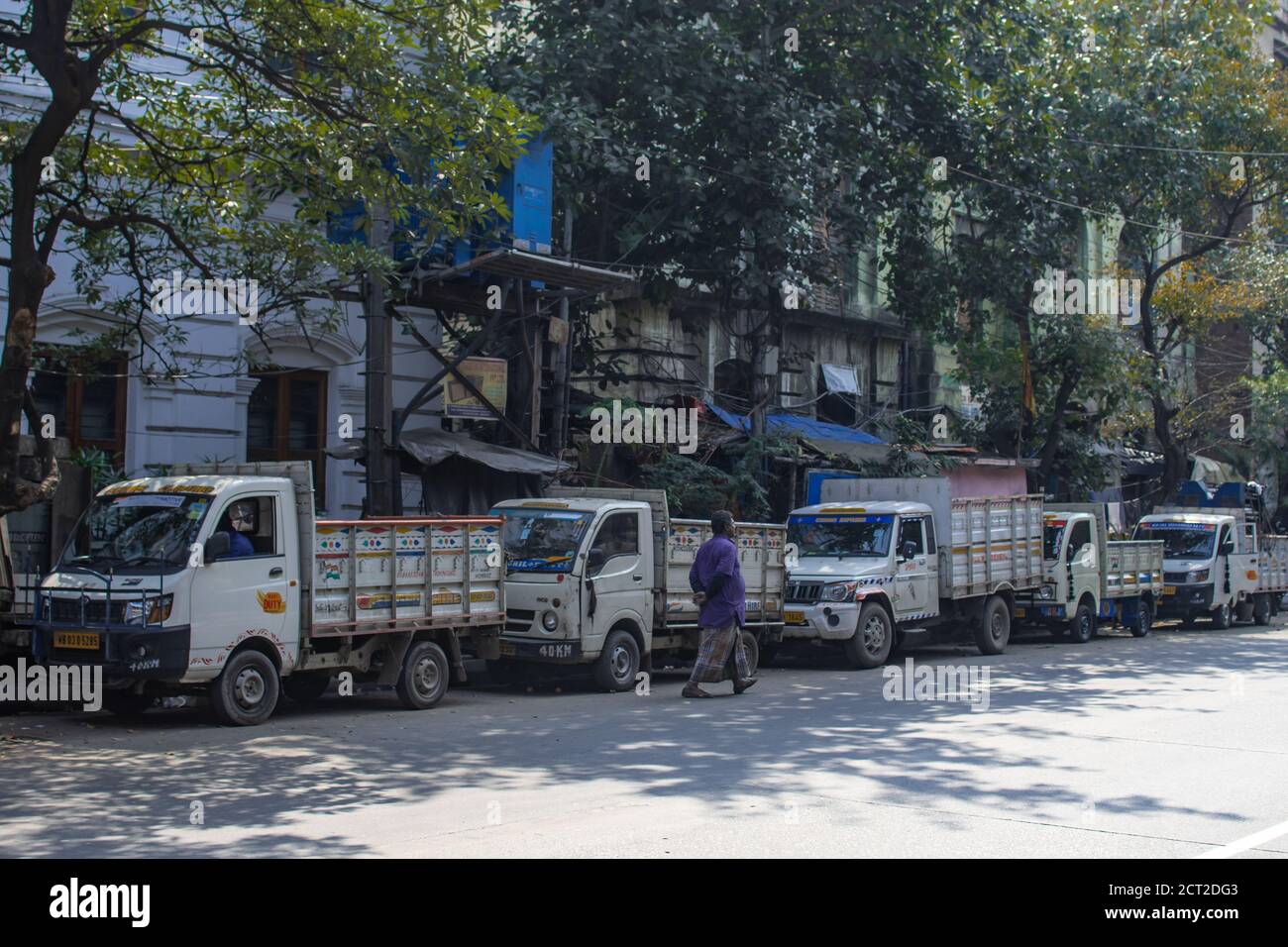 Kolkata, Indien - 1. Februar 2020: Ein nicht identifizierter Mann geht am 1. Februar 2020 in Kolkata, Indien, an mehreren geparkten Sattelschlepper auf der Straße vorbei Stockfoto