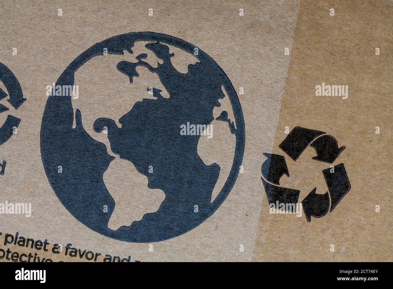 Mobius Loop-Symbol und Erdkugel-Detail auf recycelbarem Wellpappkarton – Symbol für Recycling-Recycling-Logo Stockfoto