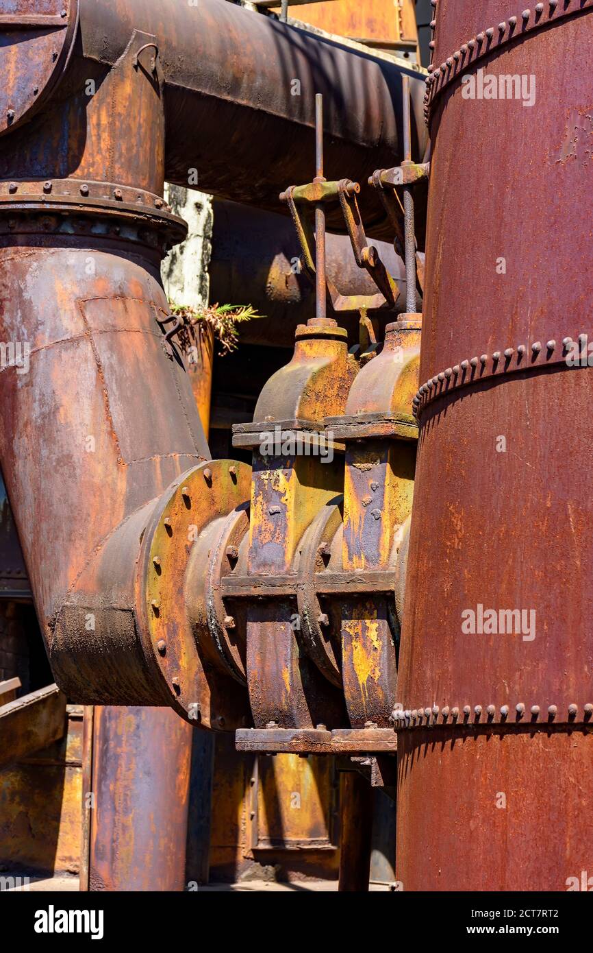 Korrodierte und rostige Getriebe und Rohrleitungen aus alten Maschinen für die Verarbeitung von Eisenerz in Minas Gerais, Brasilien Stockfoto