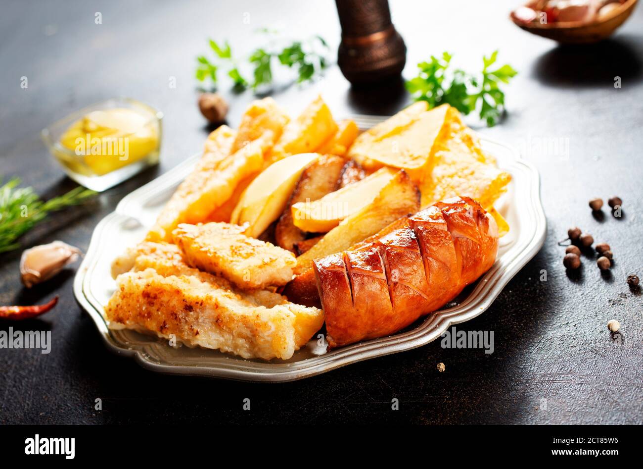 Gebratene Wurst Kartoffel Fisch Filet und Nachos Stockfoto