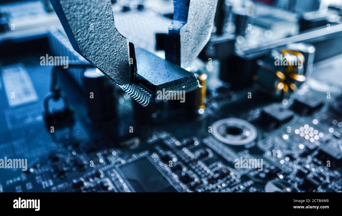 Makro-Nahaufnahme der Fabrik Maschine bei der Arbeit: Leiterplatte wird mit Roboterarm montiert, Surface Mounted Technology Connecting Microchi Stockfoto