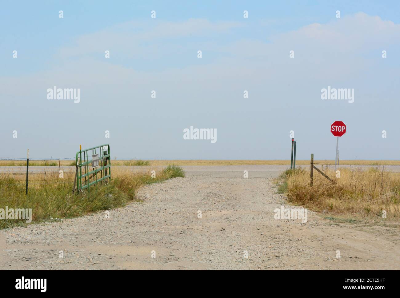 Colorado Landschaft mit Feldweg, Landstraße und Stoppschild Stockfoto