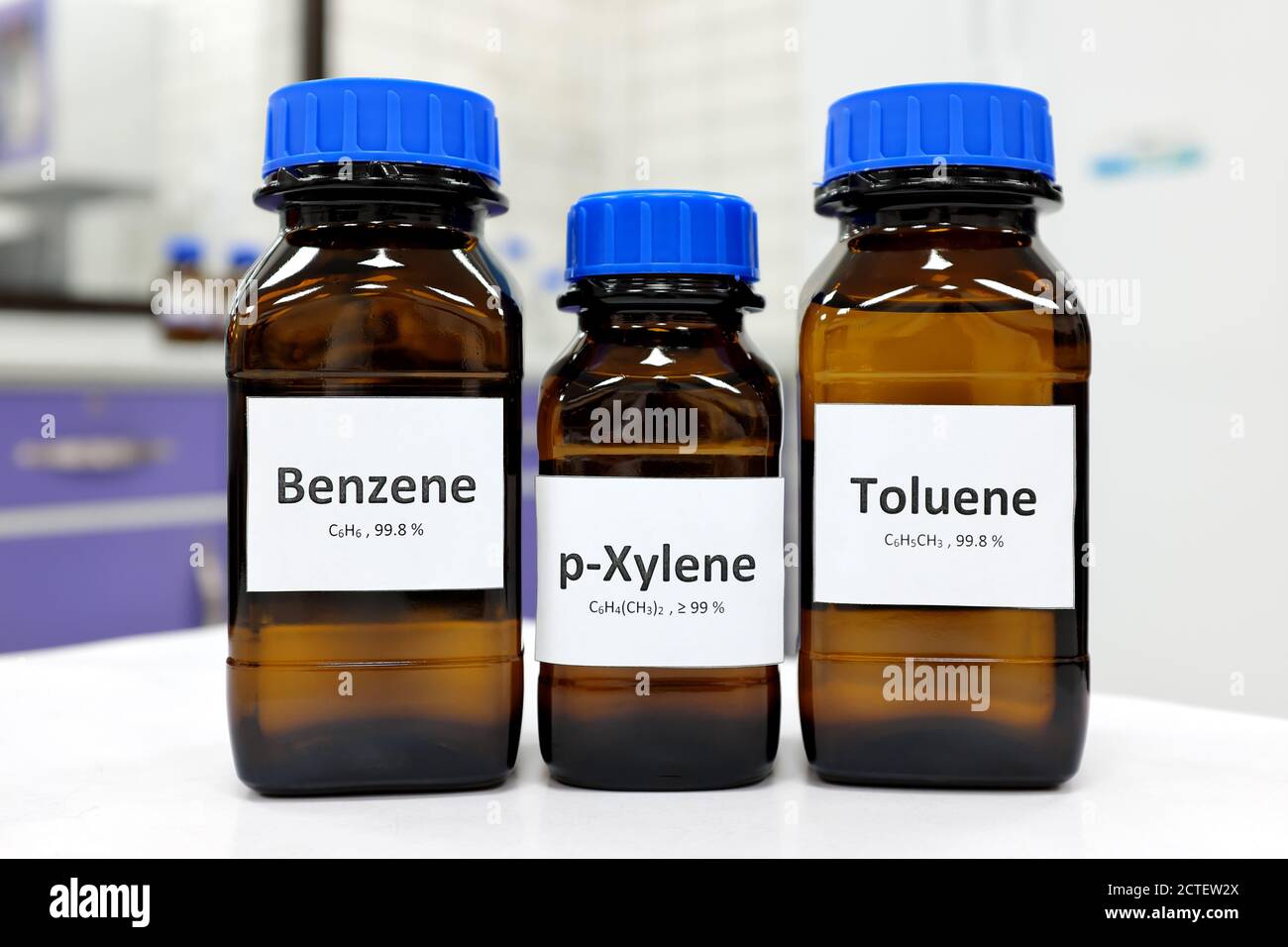 Selektiver Fokus der chemischen Verbindung von Benzol, Toluol und Xylol in einer Bernsteinflasche in einem Chemielabor mit Kopierraum. BTX aromatische Kohlenwasserstoffe. Stockfoto