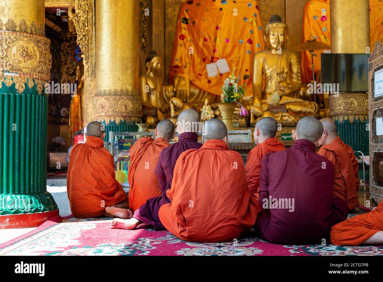 Gruppe von Mönchen, die in der Shwedagon Pagode in Yangon, Burma, Myanmar beten Stockfoto