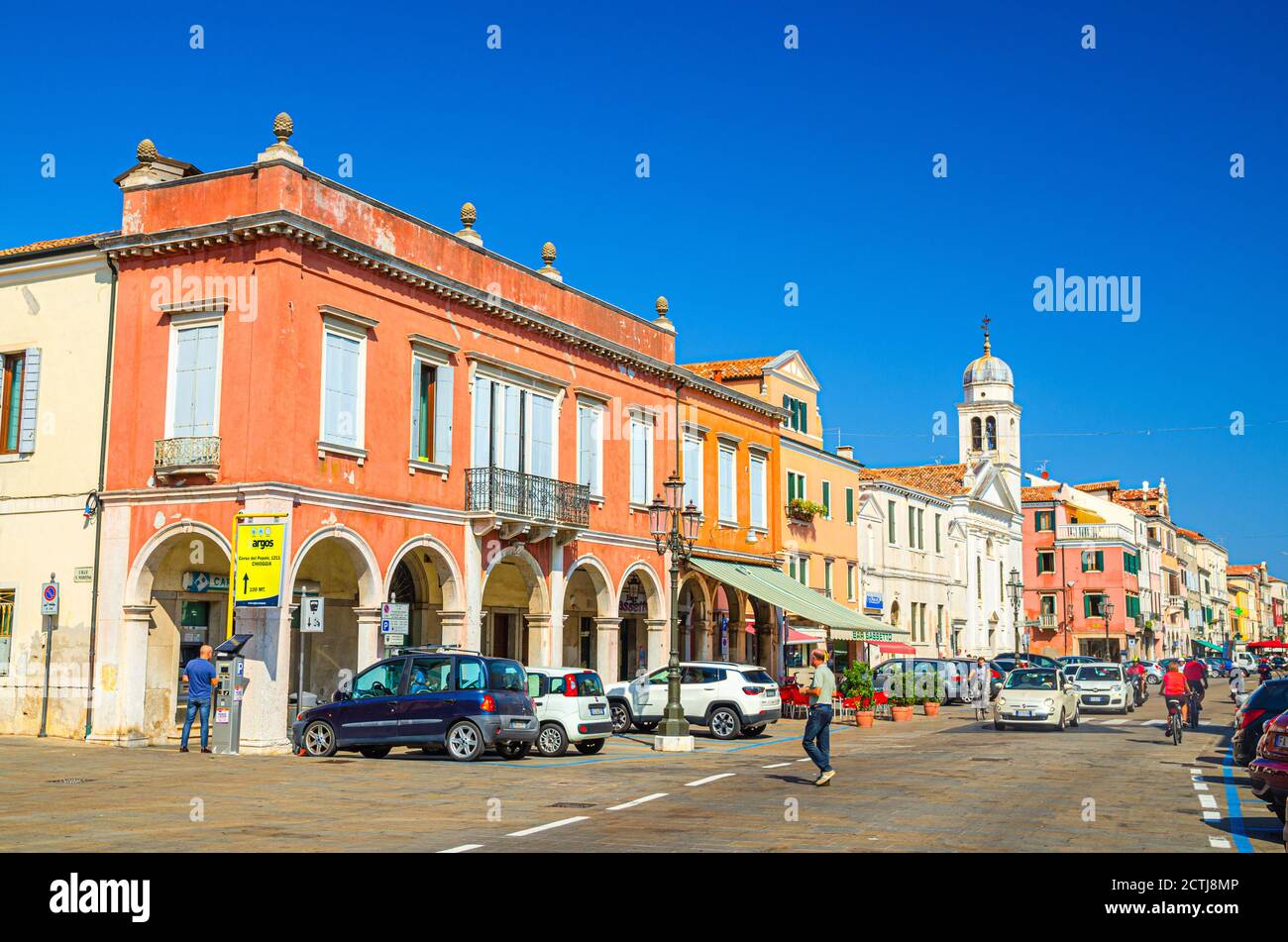 Chioggia, Italien, 16. September 2019: Reihe von bunten bunten Gebäuden auf der Hauptstraße Corso del Popolo in Chioggia historischen Zentrum, blauer Himmel Hintergrund im Sommer, Region Venetien Stockfoto