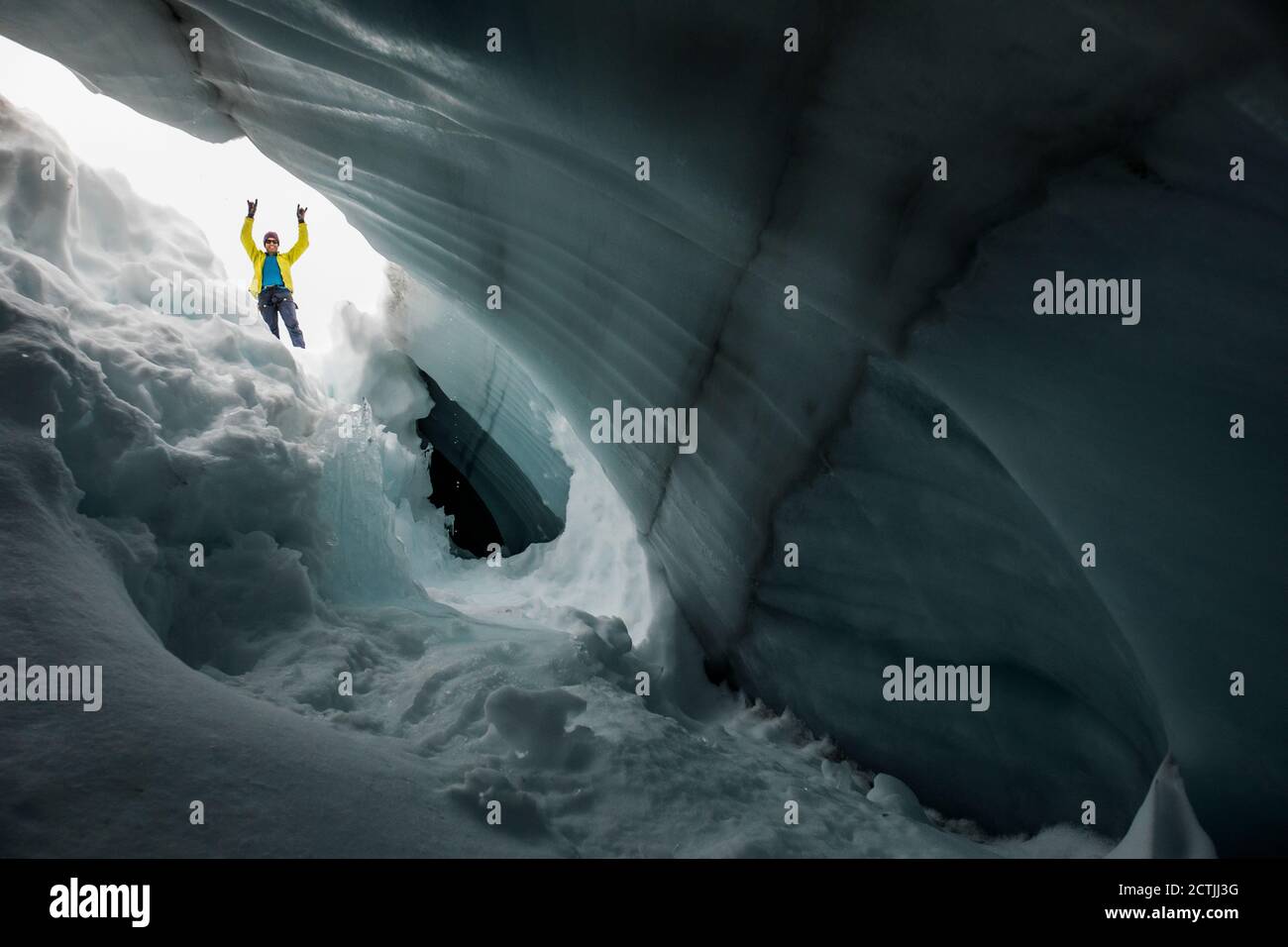 Lustiges Porträt des Kletterers Paul Mcsorley durch Gletscherspalte gesehen. Stockfoto