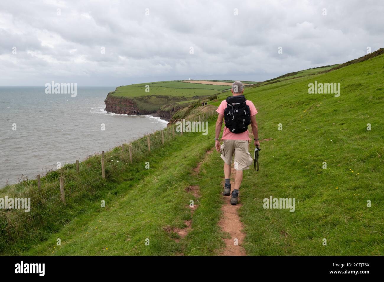 walker verlässt St Bees auf der ersten Etappe von Wainwright's Coast to Coast Long distance footpath, Cumbria, England, Großbritannien Stockfoto