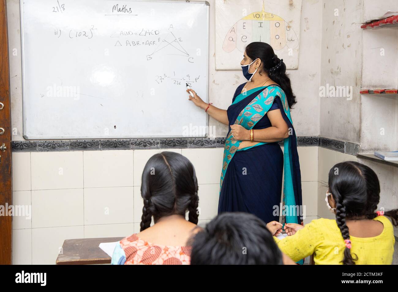 Indische Lehrer und Schüler tragen Gesichtsmasken Aufrechterhaltung der sozialen Distanzierung Studie im Klassenzimmer zurück in der Schule während covid19 Pandemie. Stockfoto