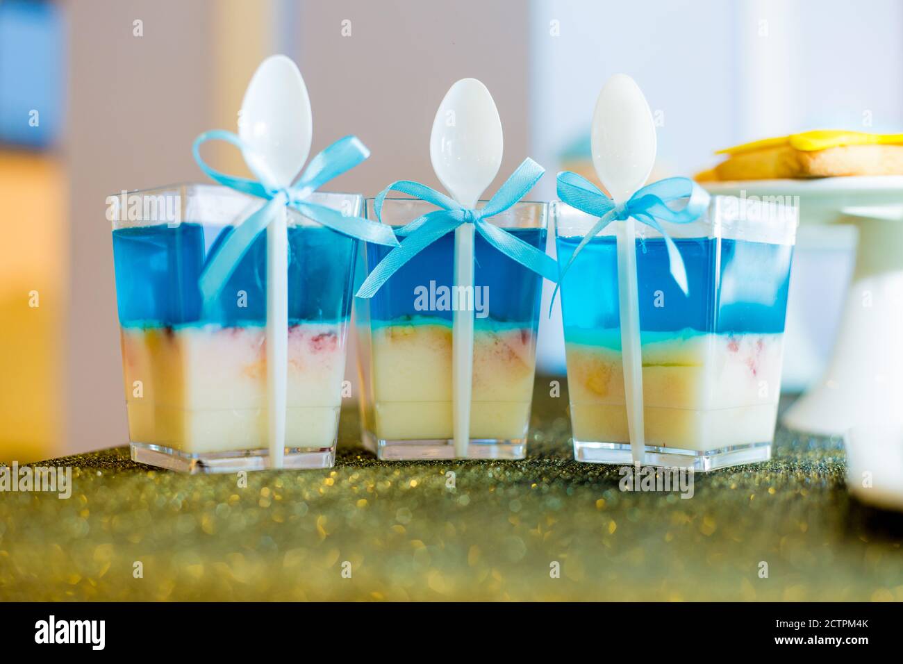 Leckere Geburtstagsjellies mit blauen Bändern gebunden Stockfoto