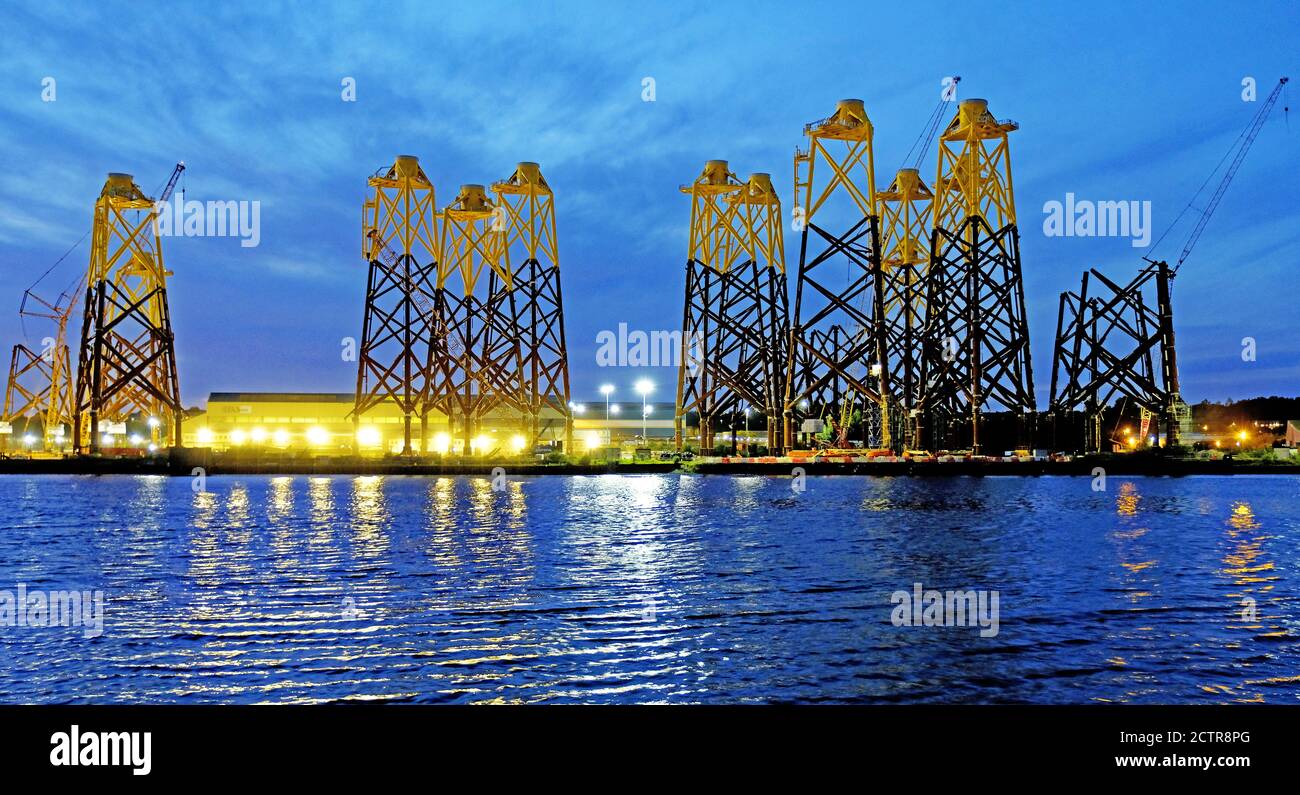 Bei Sonnenuntergang werden bei Smulders Basiseinheiten für Windkraftanlagen gebaut Howdon Tyneside Hof Tyne und tragen zu geliefert werden Das Nigg-Feld in Schottland Wann Stockfoto