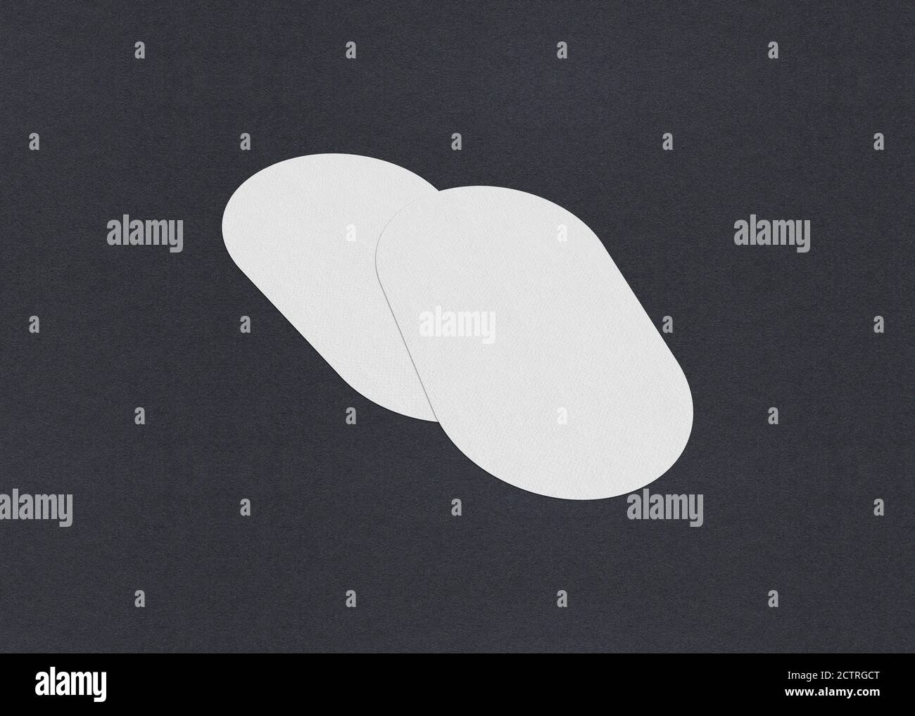 Leere weiße Visitenkarten-Mockup-Stapel auf grauem texturiertem Papierhintergrund. Stockfoto