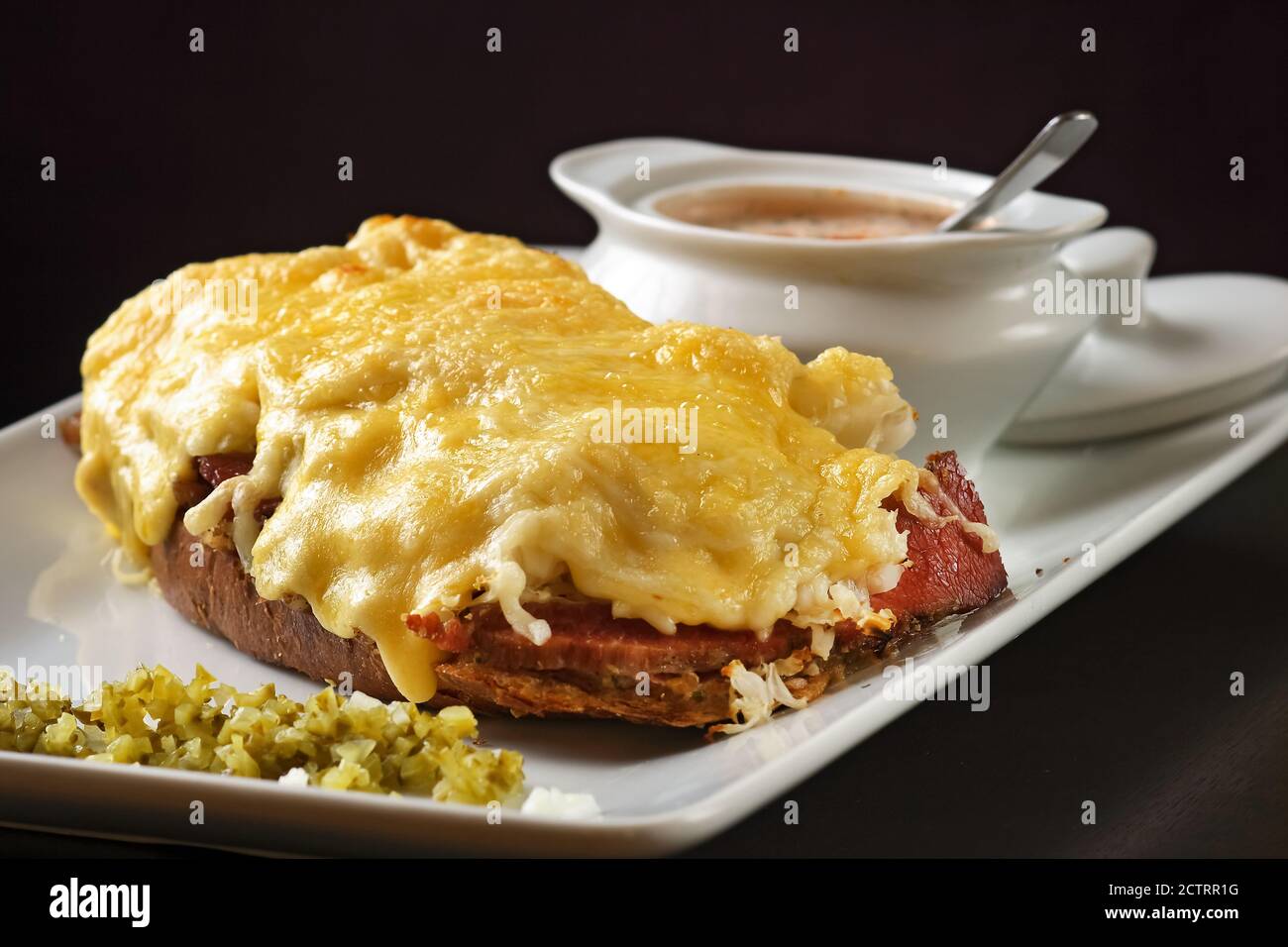 Pastrami-Sandwich mit Käseauflage und Rosésauce Stockfoto