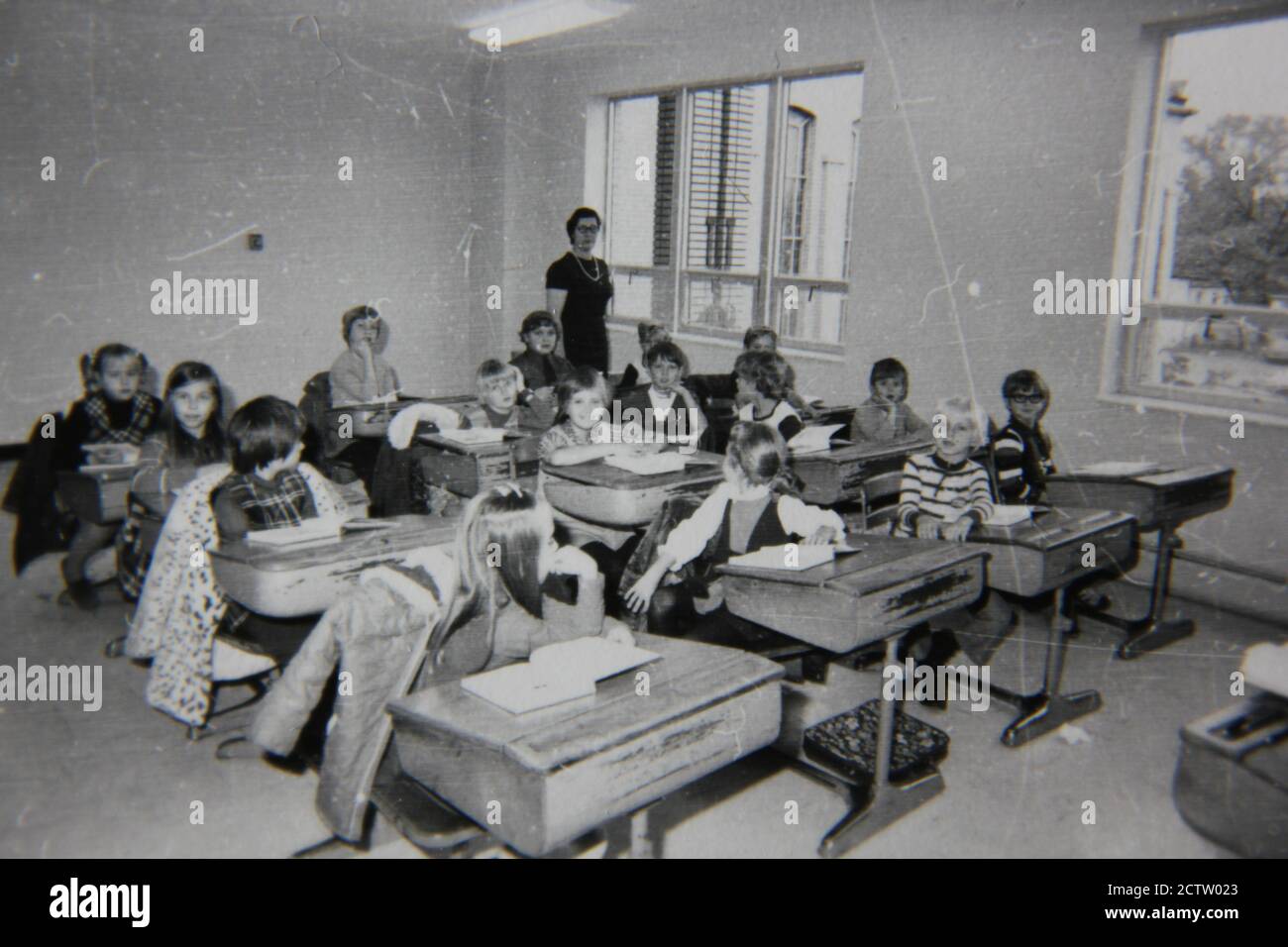 Feine Vintage-Schwarz-Weiß-Fotografie der 1970er Jahre von Grundschülern, die in ihren Klassenzimmern sitzen und ihren Unterricht lernen. Stockfoto