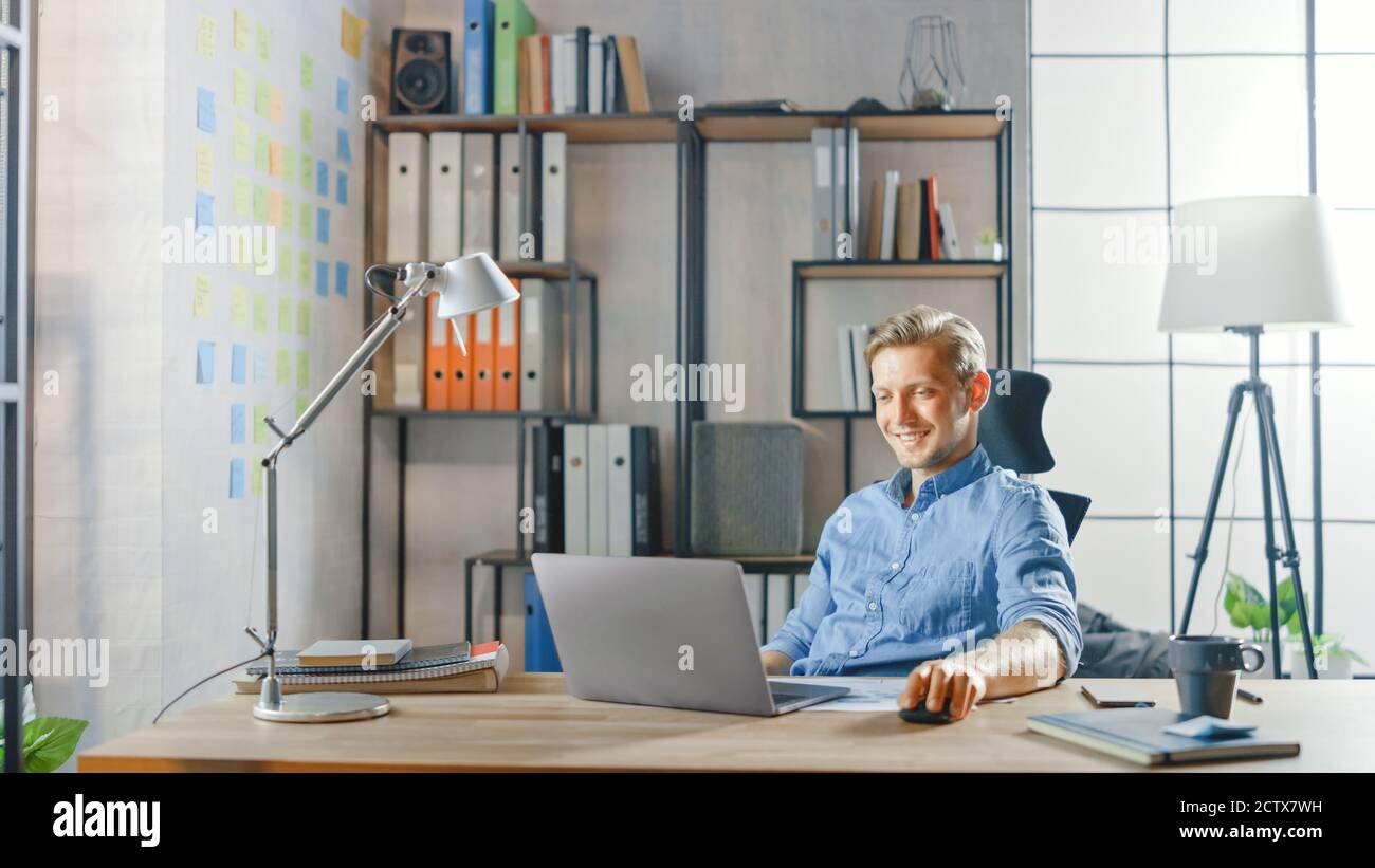 Creative Entrepreneur sitzt an seinem Schreibtisch arbeitet auf einem Laptop im stilvollen Büro, nutzt Notebook für Social Media Apps, E-Mail-Business Associates Stockfoto
