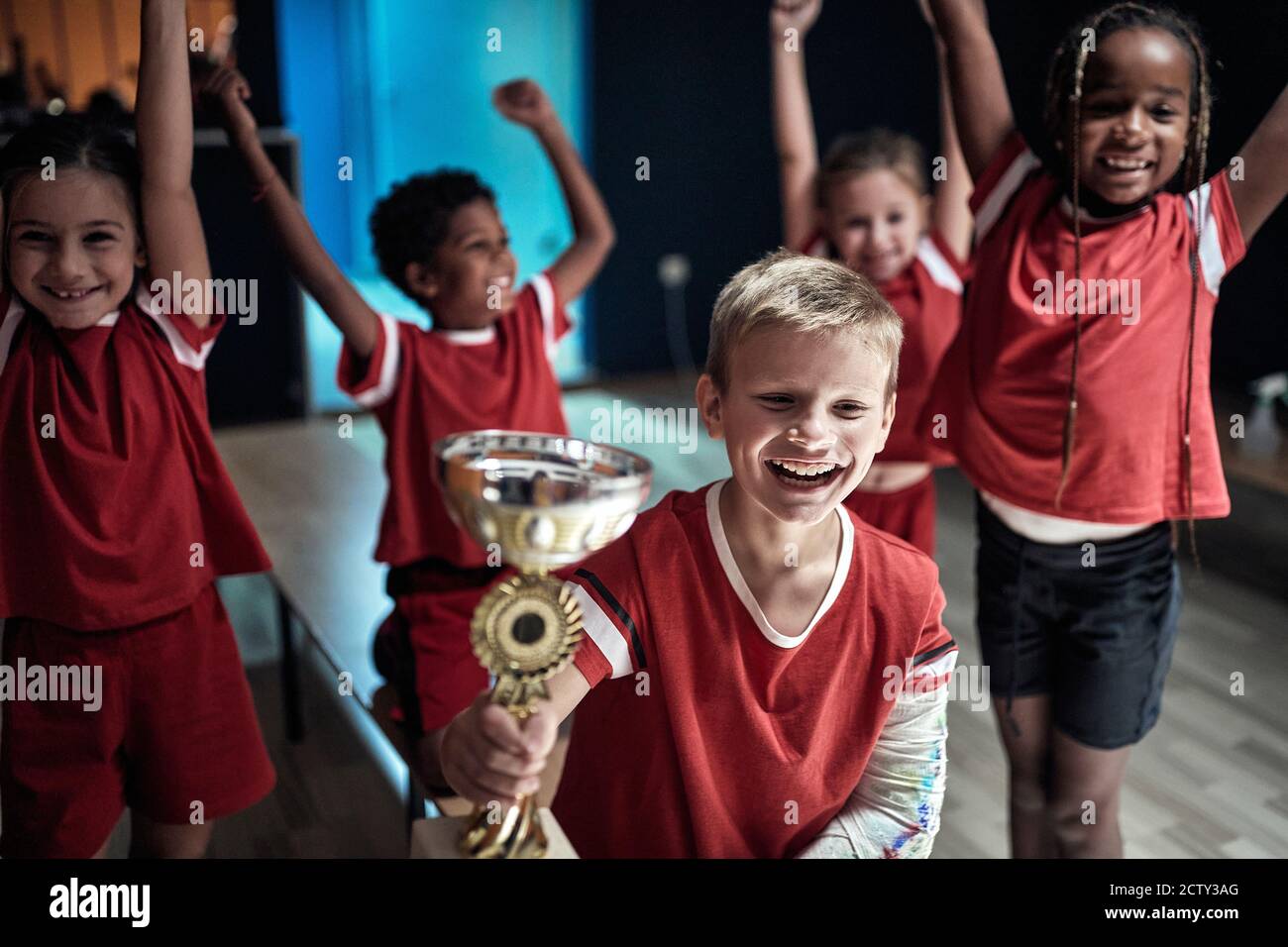 Die kleinen Fußballspieler feiern den Sieg in einem Schließfach Zimmer Stockfoto