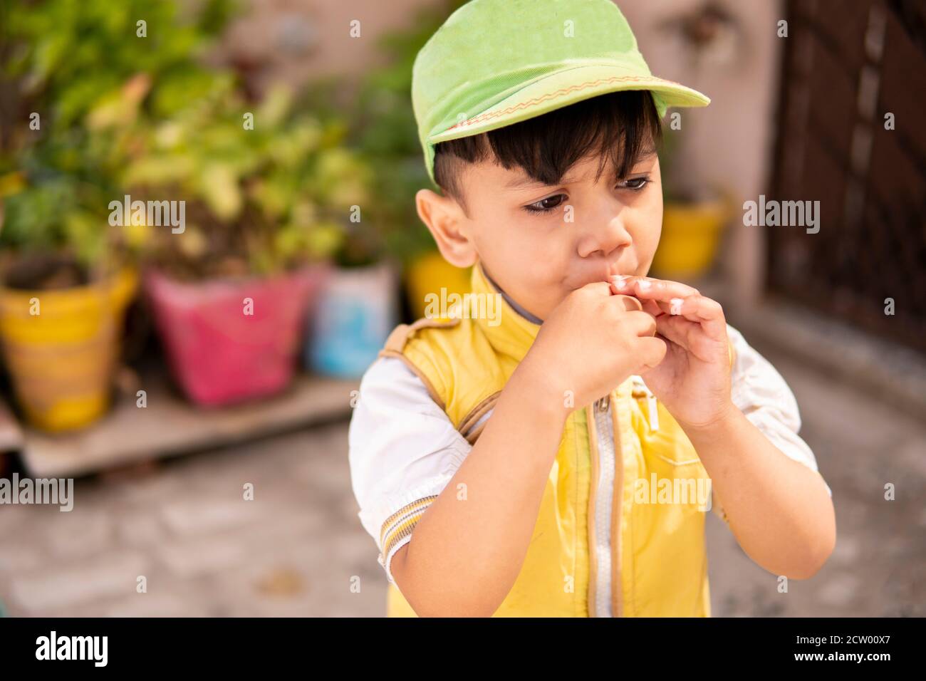 Schneiden Sie kleinen Jungen essen Lollipop Süßigkeiten und Spaß im Freien zu Tageszeiten. Stockfoto