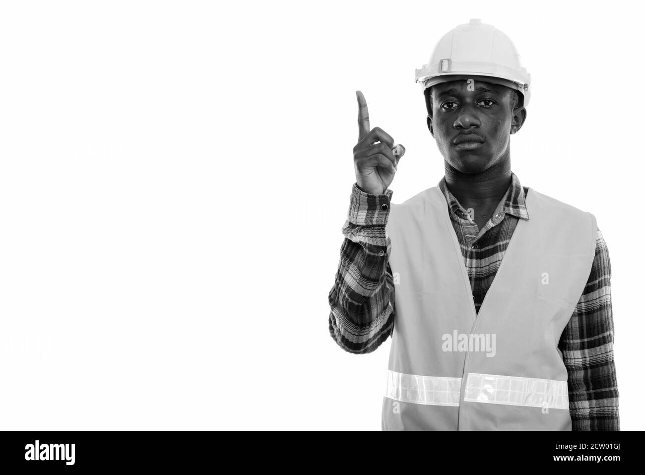 Studio shot von jungen schwarzen afrikanischen Mann Bauarbeiter zeigen mit dem Finger auf Stockfoto