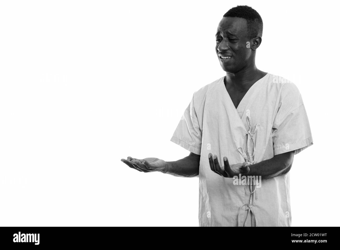 Studio shot von jungen schwarzen afrikanischen Mann Patienten traurig und verwirrt Stockfoto