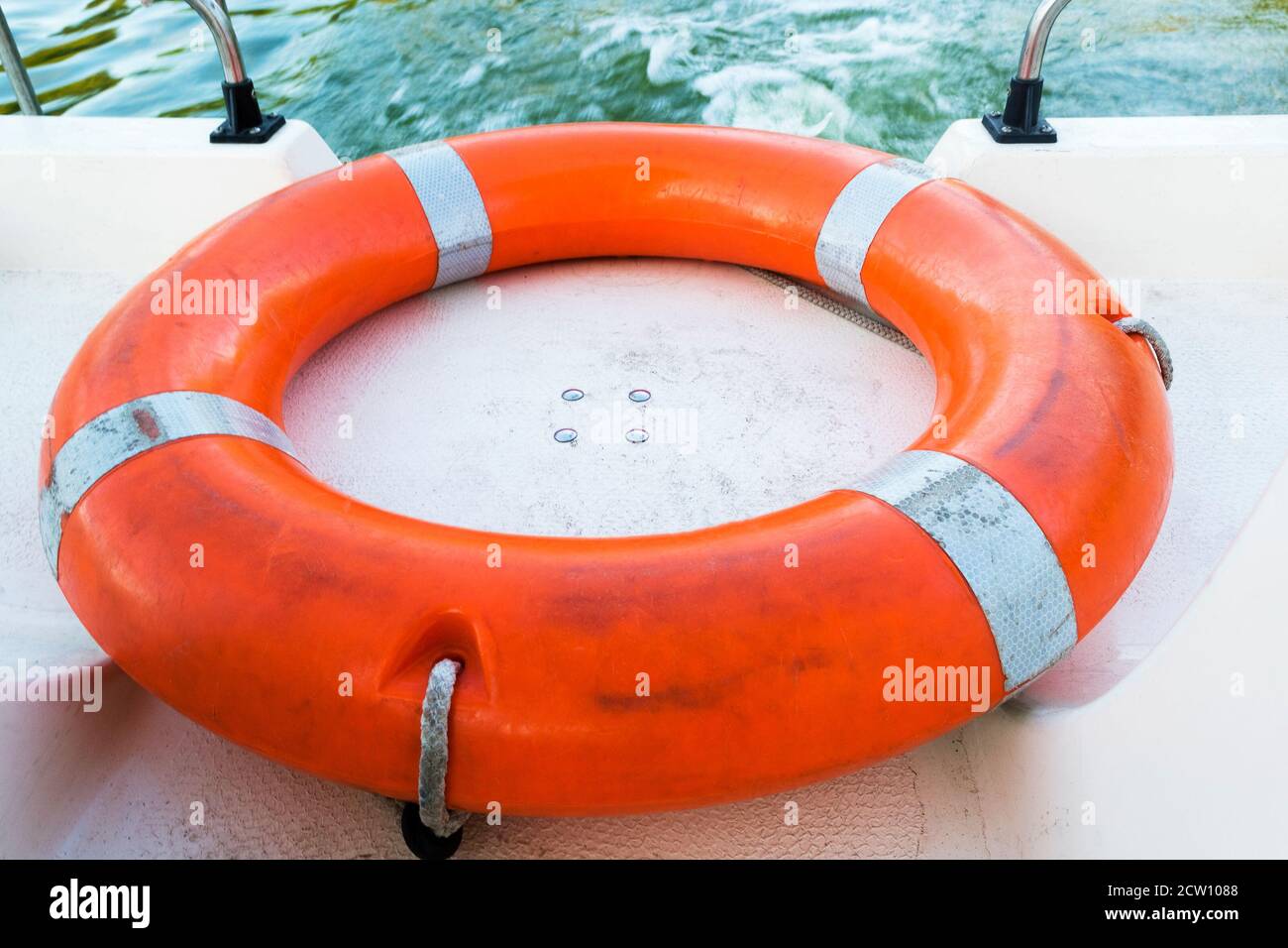 Sicherheitsausrüstung, Rettungsring oder Rettungsring. Persönliche Flotationseinrichtung zum Ertrinken. Orange Rettungsschwimmer auf dem Deck eines Schiffes. Stockfoto