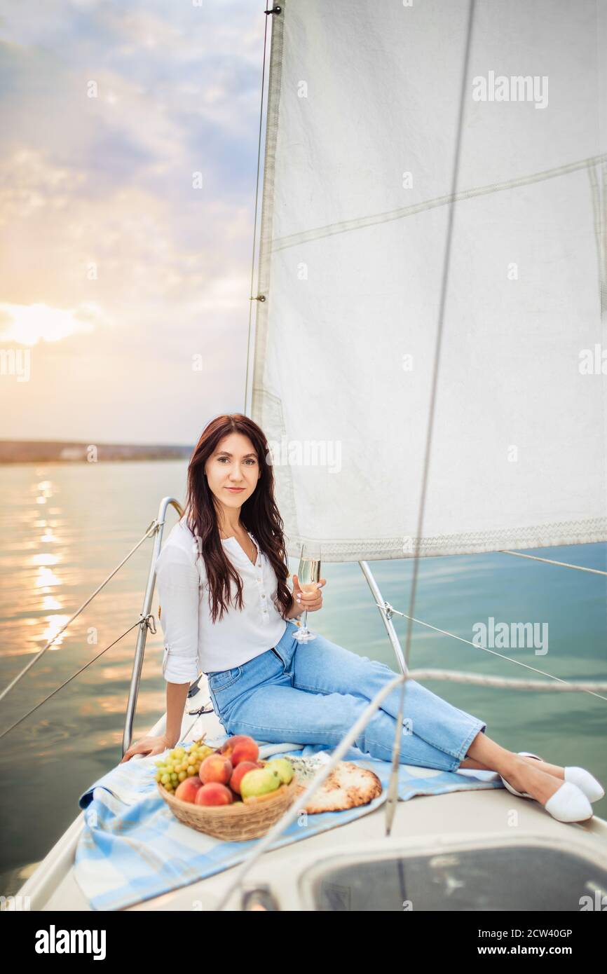 Frau mit einem Glas Champagner auf der Yacht Stockfoto